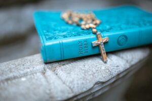 Rosary draped over holy bible